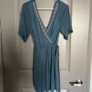Wrap dress with great detail and open back with tie